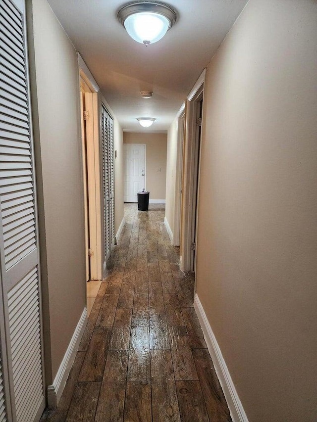 corridor with wood-type flooring