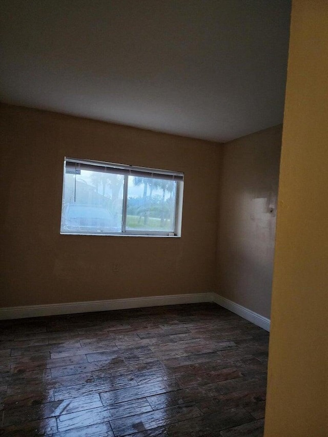 unfurnished room with dark hardwood / wood-style floors