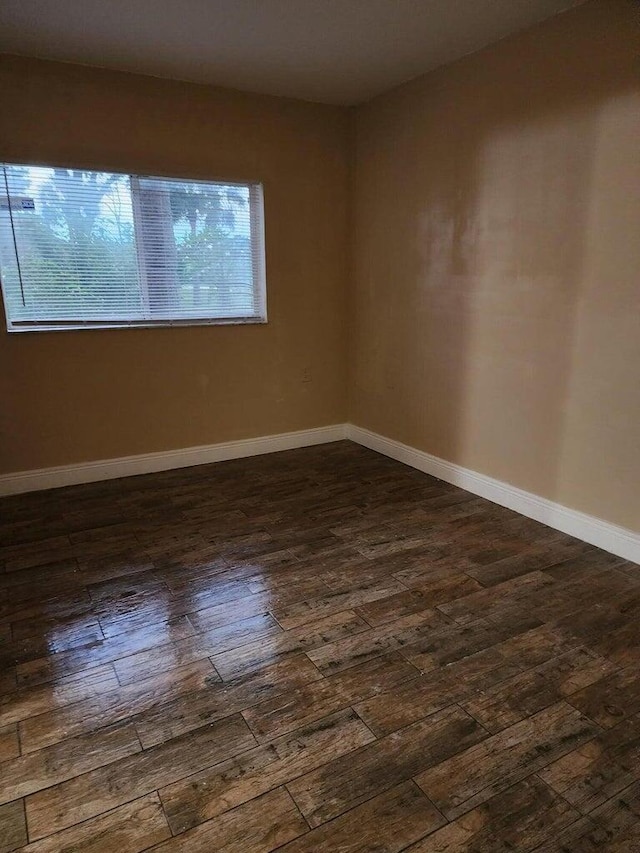 spare room with dark hardwood / wood-style flooring