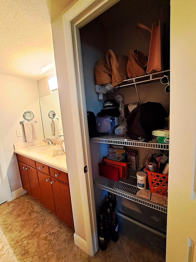 interior space featuring vanity and a textured ceiling