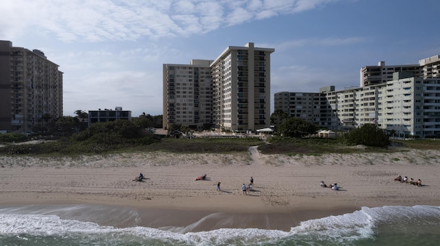 view of property featuring a water view and a beach view