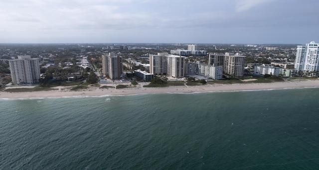 bird's eye view with a water view and a beach view