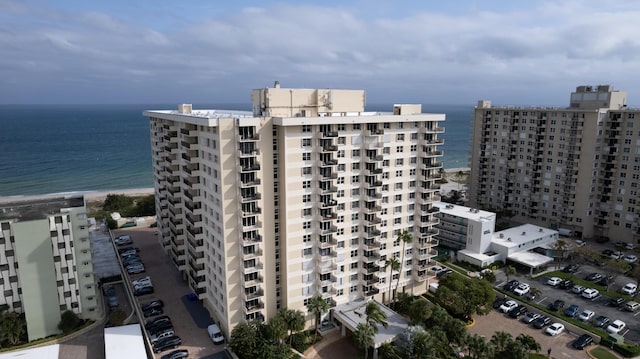 view of property featuring a view of the beach and a water view