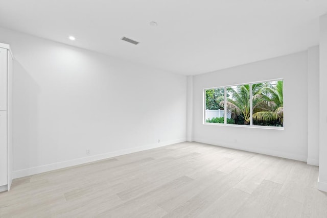 unfurnished room with light hardwood / wood-style flooring