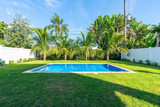 view of pool featuring a lawn