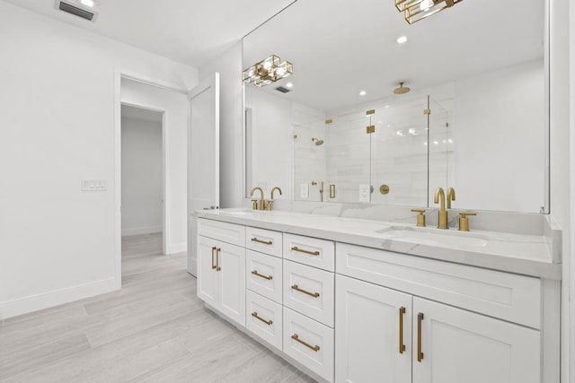 bathroom featuring vanity and a shower with door