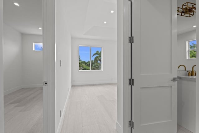 hall with light hardwood / wood-style floors