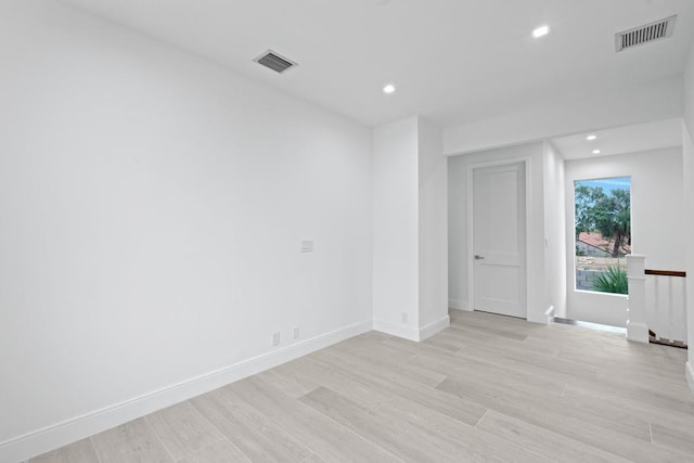 unfurnished room with light hardwood / wood-style floors