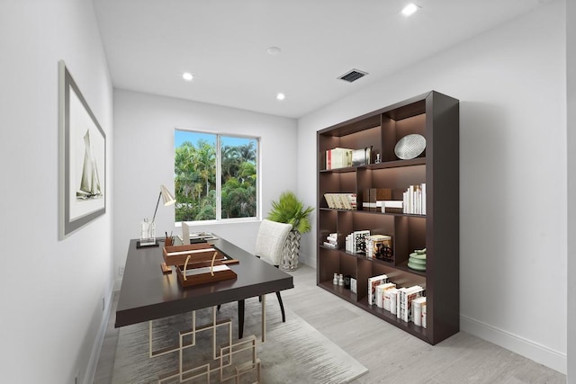 office space with light wood-type flooring