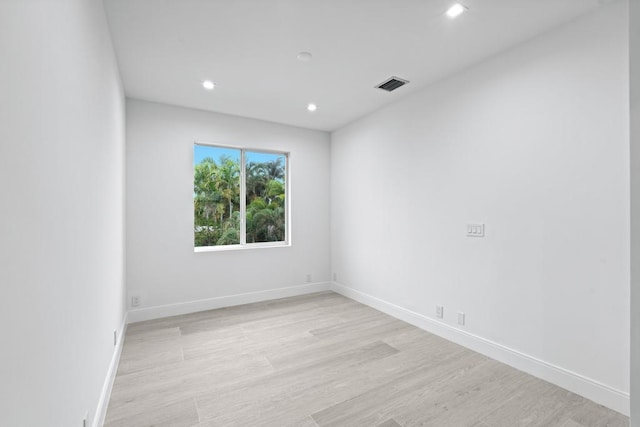 unfurnished room with light hardwood / wood-style floors