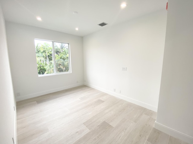 unfurnished room with light hardwood / wood-style floors