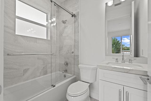 full bathroom with vanity, toilet, and combined bath / shower with glass door