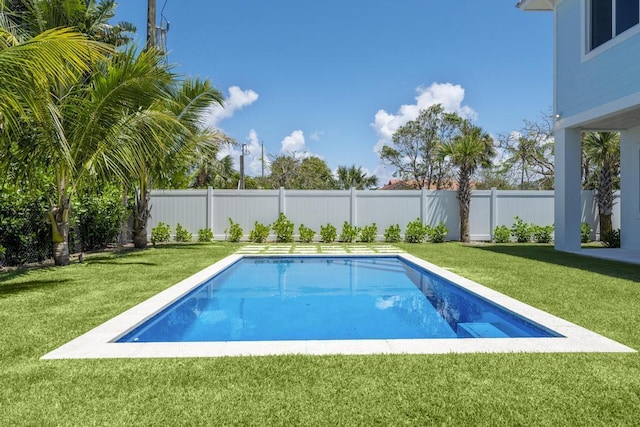 view of pool with a lawn