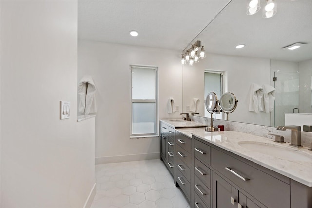 bathroom featuring tile patterned flooring, vanity, and a shower with shower door