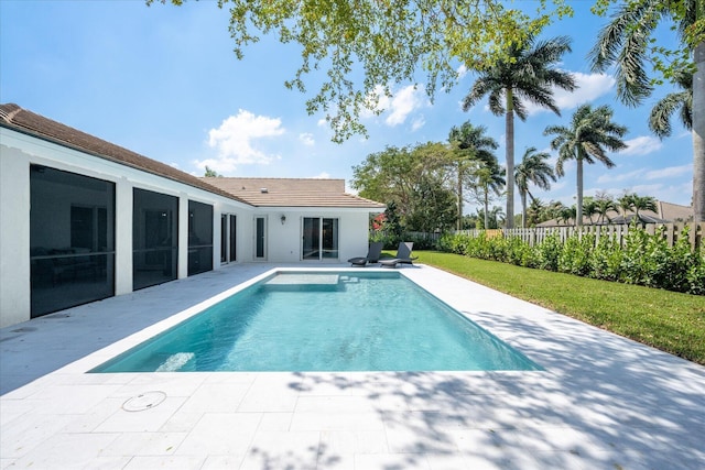 view of swimming pool featuring a yard and a patio area