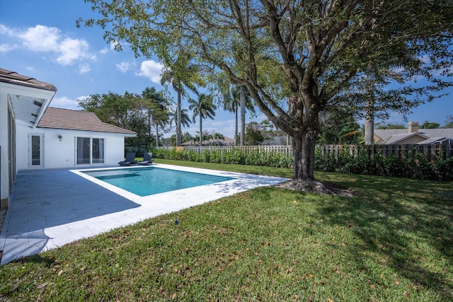 view of swimming pool with a yard and a patio area