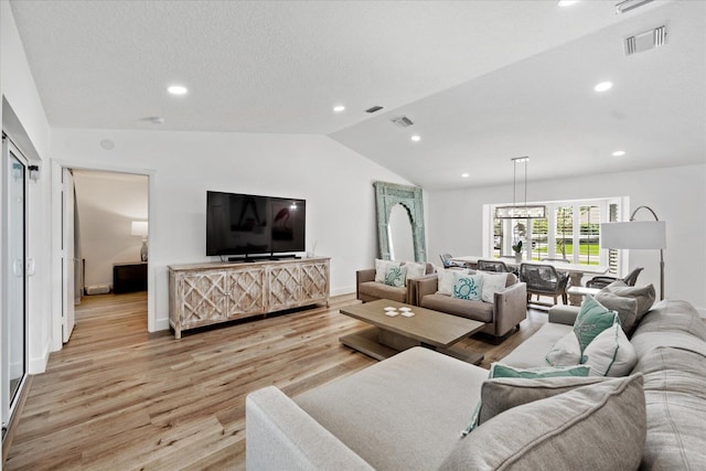 living room featuring light hardwood / wood-style flooring and vaulted ceiling