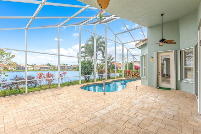 view of swimming pool featuring a water view, ceiling fan, a lanai, and a patio