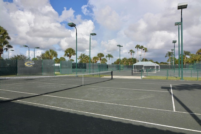 view of sport court featuring fence