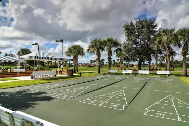 view of home's community featuring a yard and shuffleboard