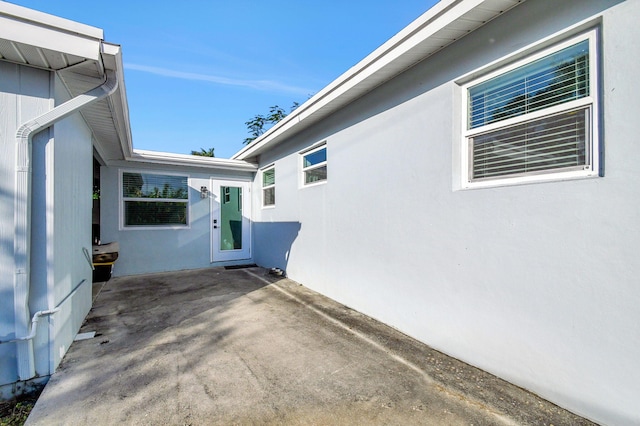 view of side of home with a patio area