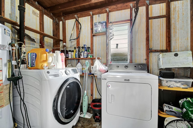 laundry area with separate washer and dryer and water heater