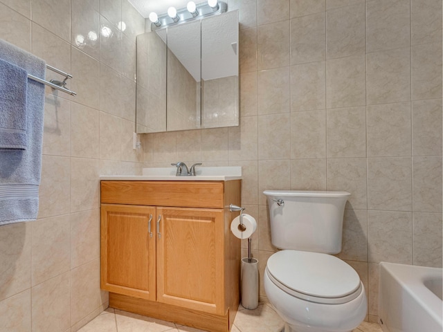 bathroom with tile patterned flooring, vanity, tile walls, and toilet