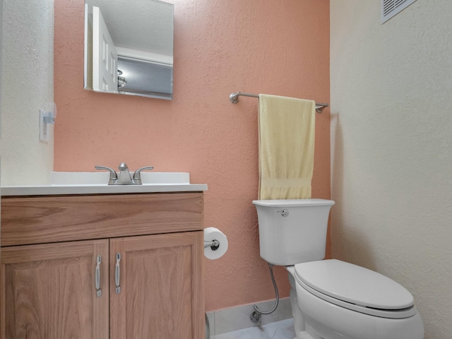 bathroom featuring tile patterned floors, vanity, and toilet