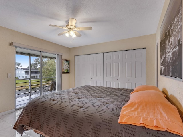 tiled bedroom with ceiling fan, access to exterior, a closet, and a textured ceiling