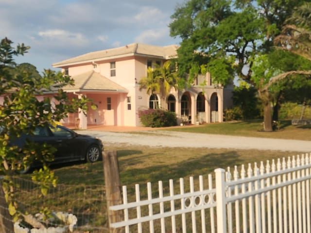 mediterranean / spanish home featuring a fenced front yard, a front yard, and stucco siding