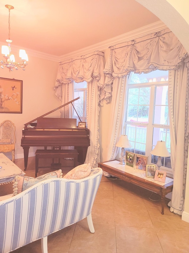 sitting room featuring tile patterned floors, plenty of natural light, an inviting chandelier, and crown molding