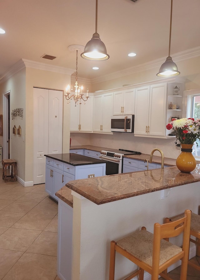 kitchen with stainless steel microwave, crown molding, visible vents, and white electric stove