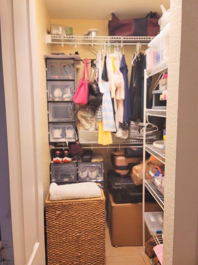 spacious closet featuring tile patterned flooring