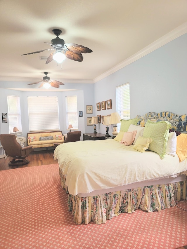 bedroom featuring multiple windows, crown molding, and ceiling fan