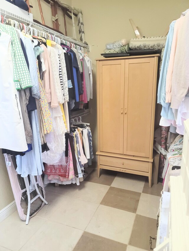 walk in closet featuring light floors