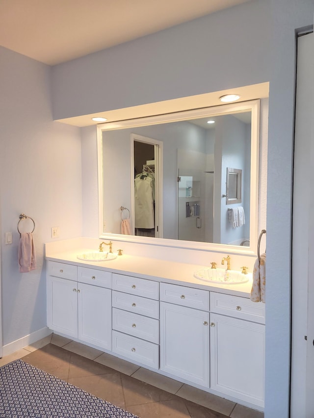 full bathroom with tile patterned floors, double vanity, and a sink