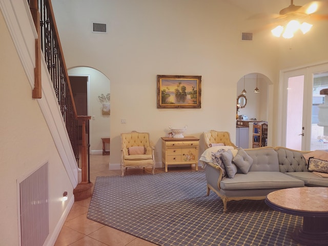 living area featuring visible vents and arched walkways