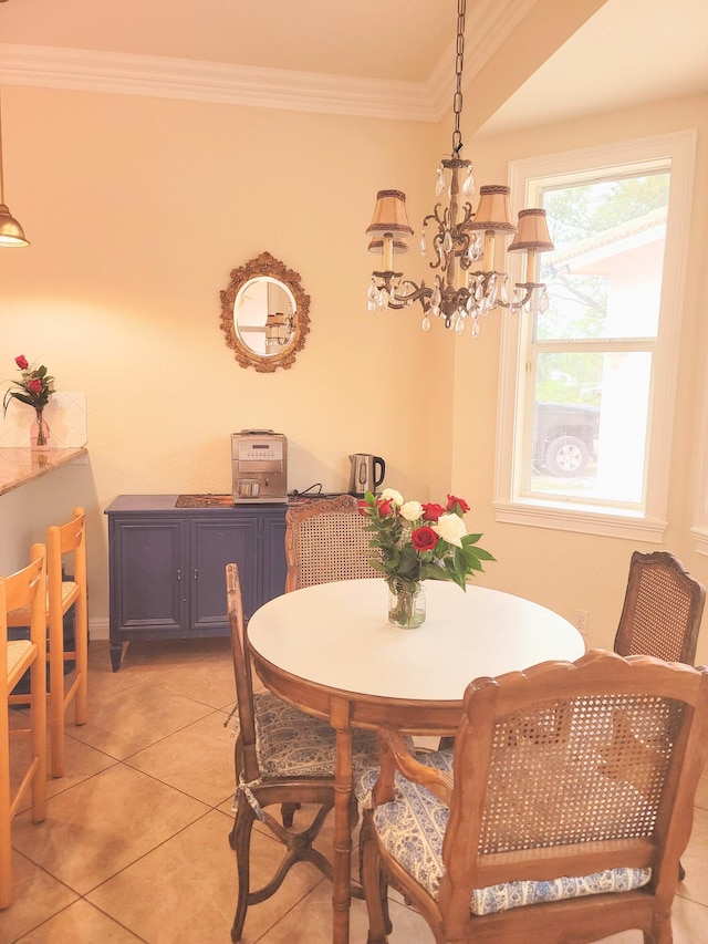 dining area featuring light tile patterned floors, an inviting chandelier, and ornamental molding