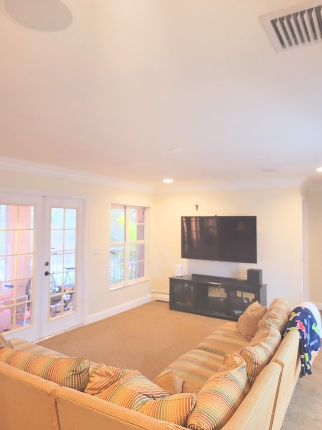 living area featuring visible vents, crown molding, baseboards, carpet flooring, and french doors