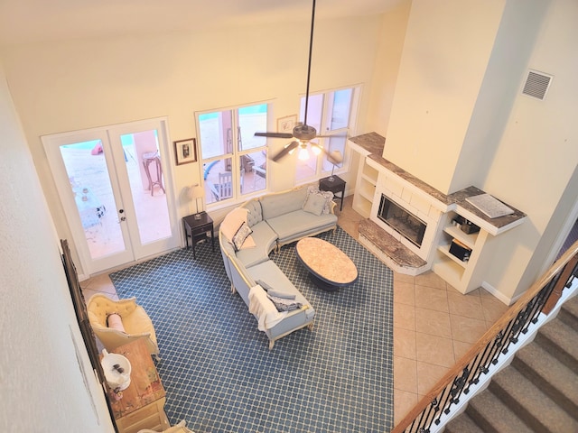 living room with visible vents, french doors, a high ceiling, baseboards, and stairs