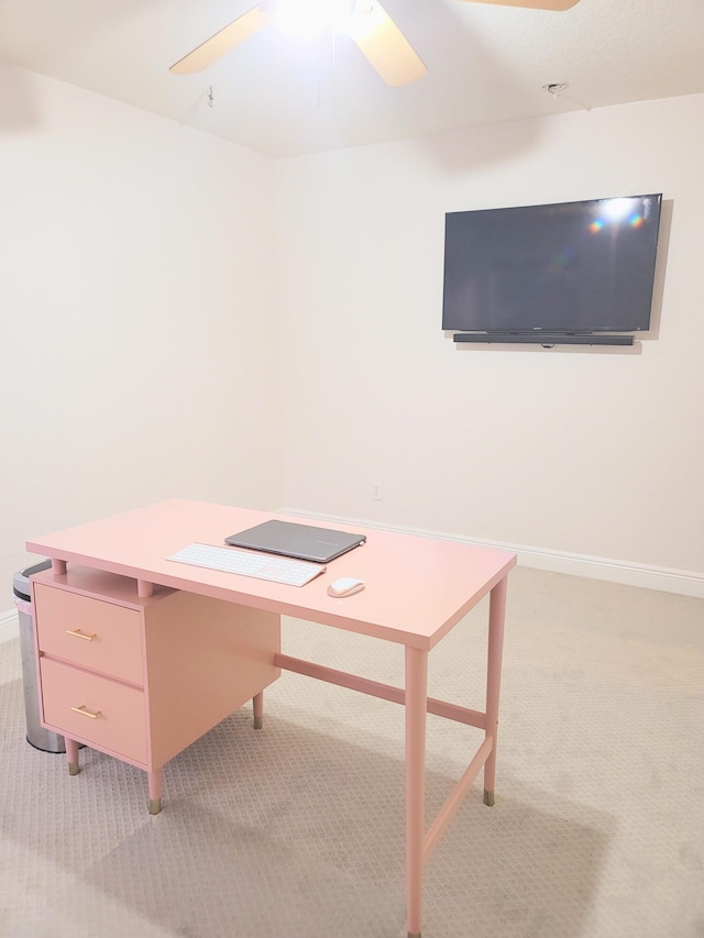 unfurnished office with light colored carpet, baseboards, and ceiling fan