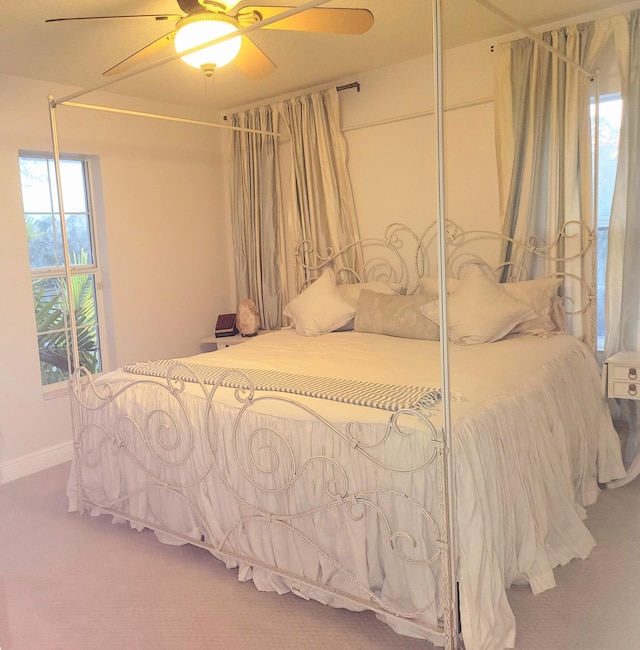 carpeted bedroom with baseboards and ceiling fan