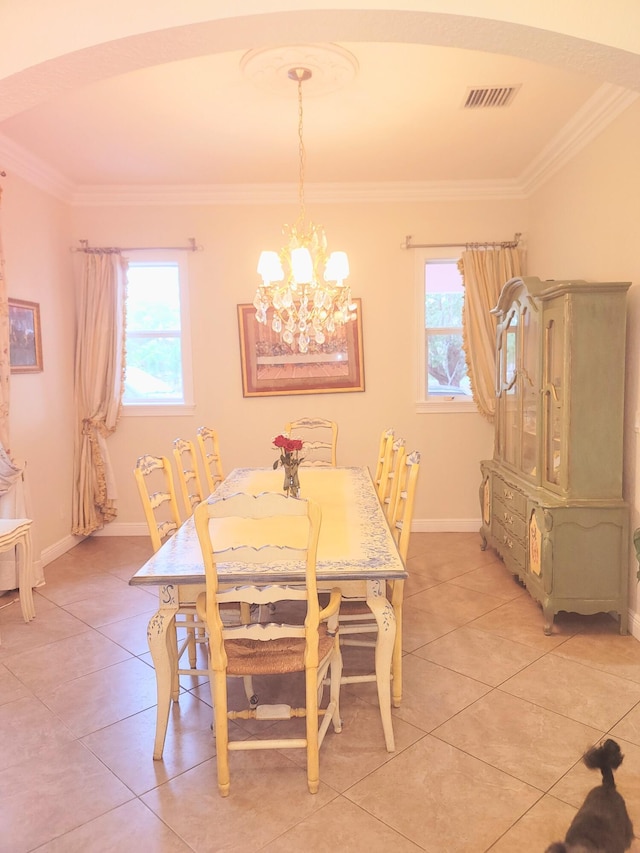 dining room with crown molding, plenty of natural light, visible vents, and a chandelier