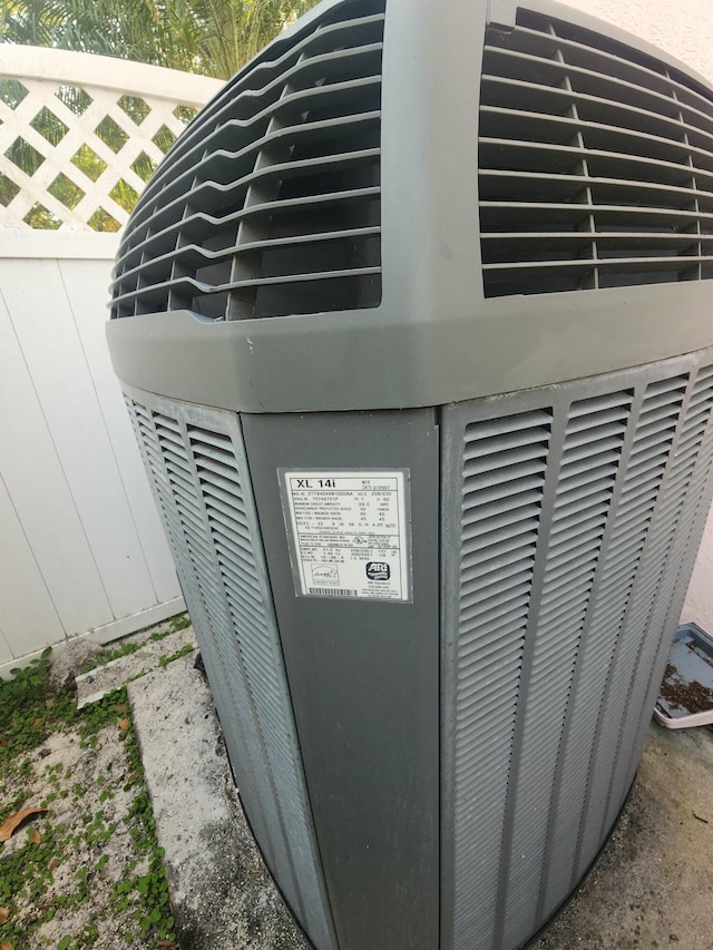 exterior details featuring cooling unit and fence