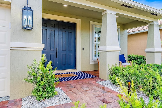 doorway to property with stucco siding