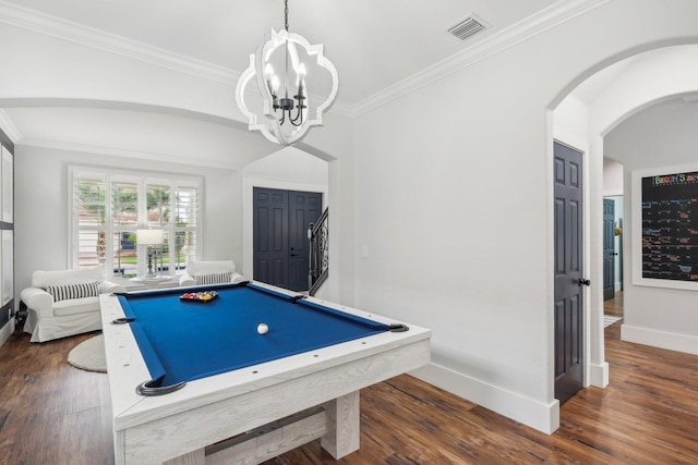 playroom with dark wood finished floors, crown molding, arched walkways, and visible vents