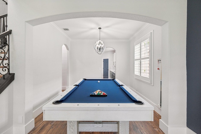 playroom featuring dark hardwood / wood-style flooring, pool table, ornamental molding, and a chandelier