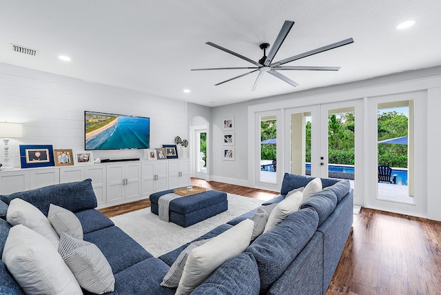 living room with hardwood / wood-style floors, plenty of natural light, and ceiling fan