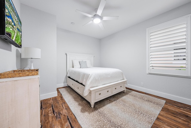 bedroom with baseboards, dark wood-type flooring, and a ceiling fan