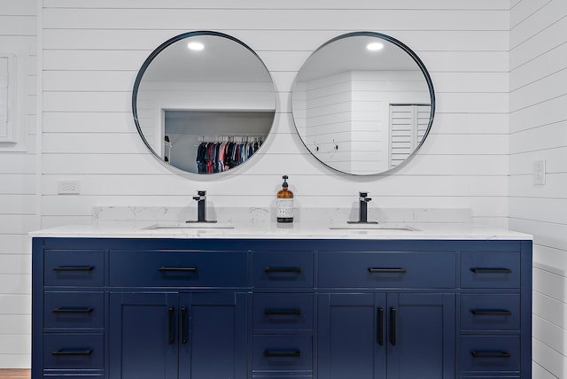 full bath featuring a sink and double vanity